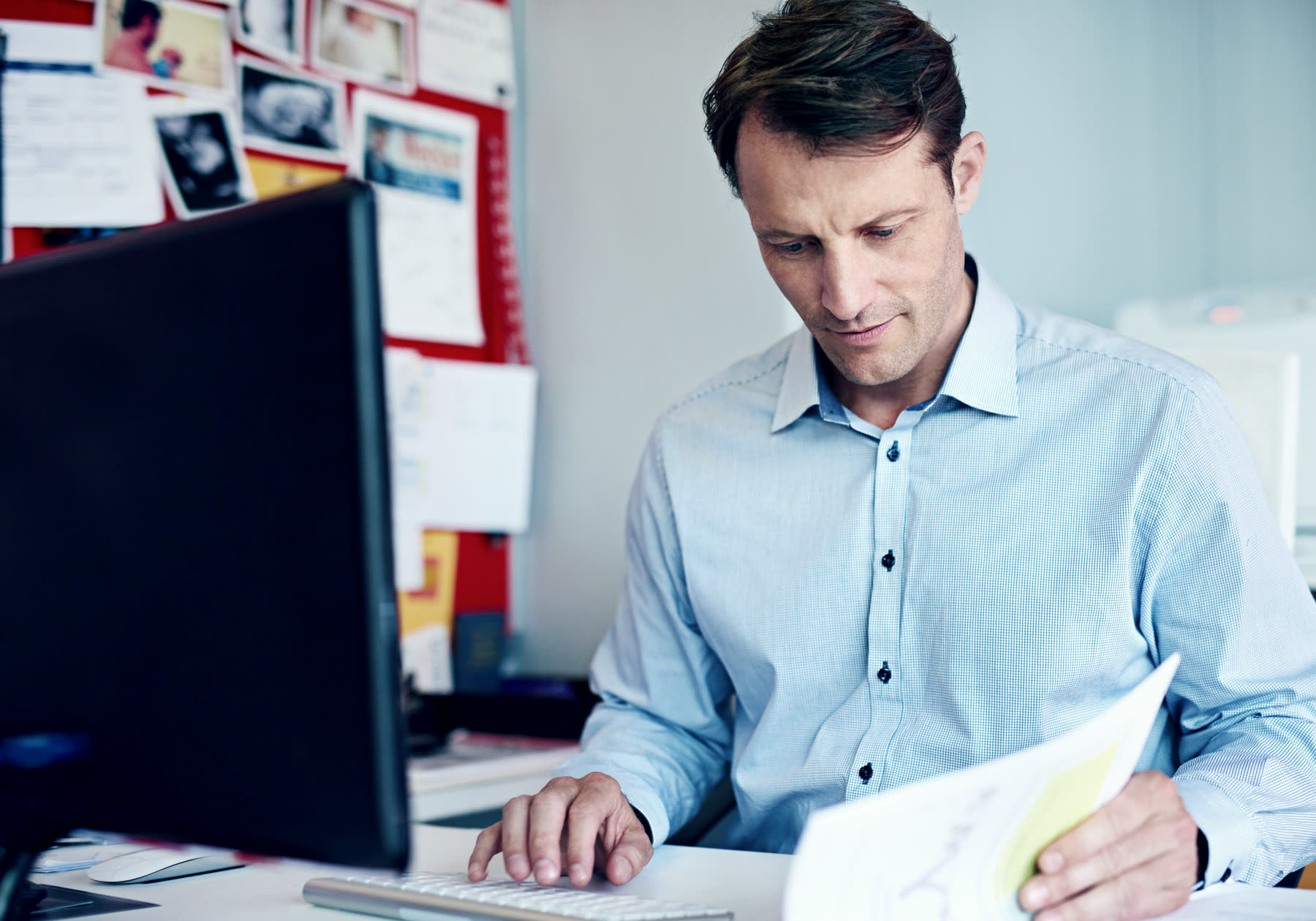Someone working through documents at a desk