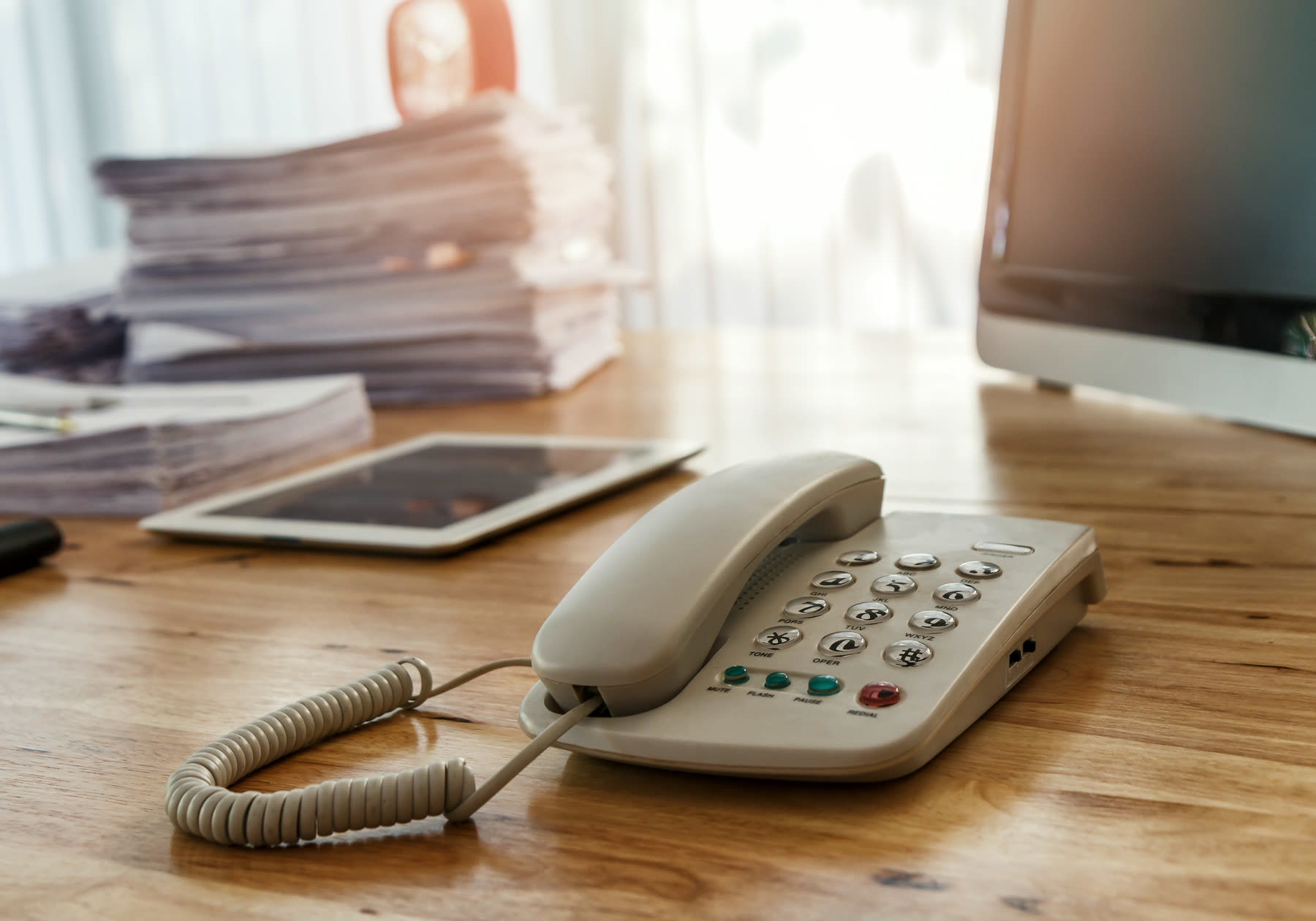 A desk telephone and notepad