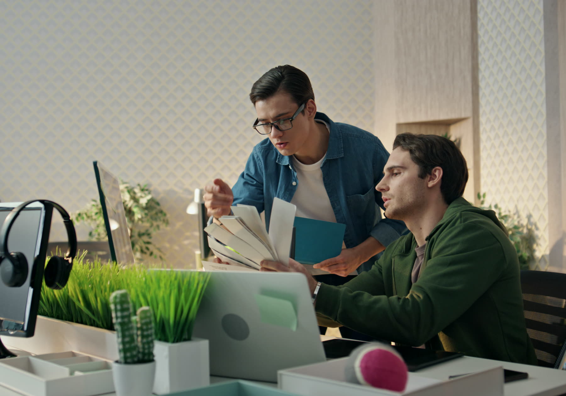 Two people reviewing work on a screen