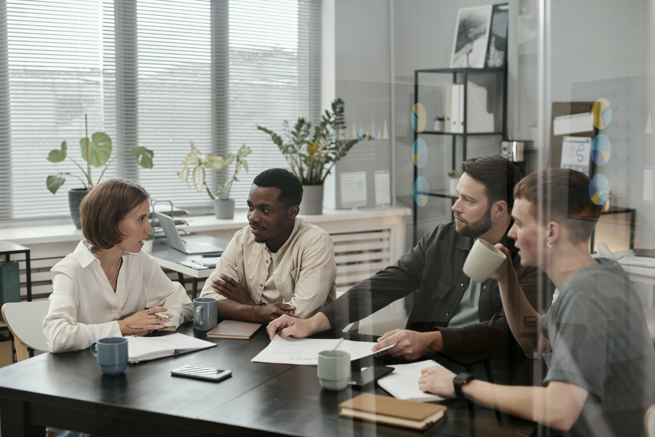 A busy open-plan office in conversation