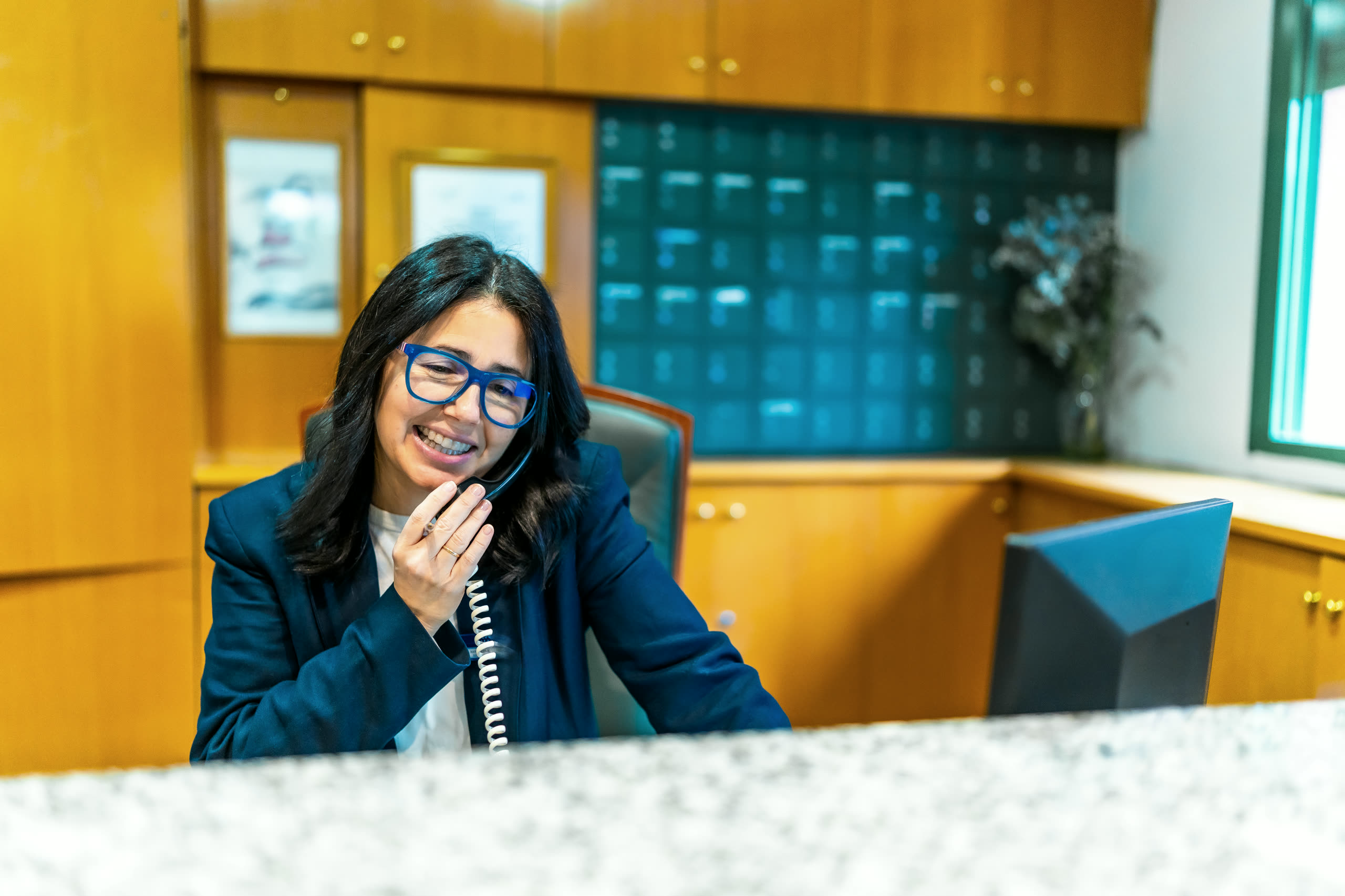 A florist answering the phone at her counter