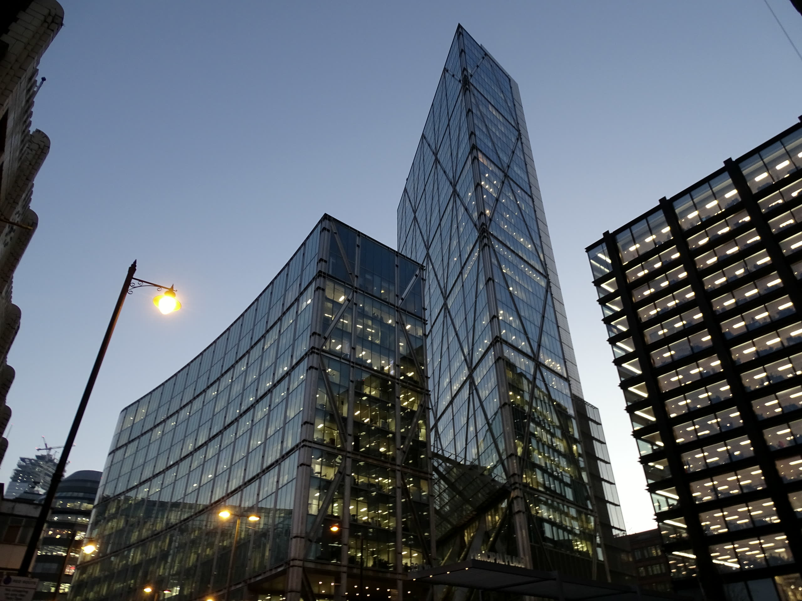 Executives walking past a modern glass office building