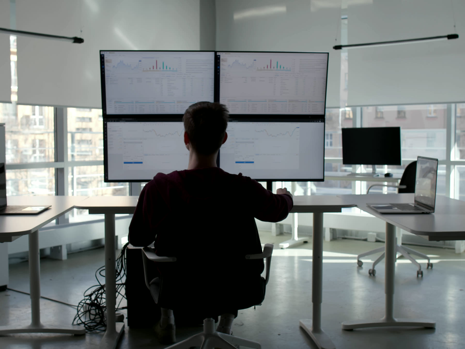 Someone working across several screens
