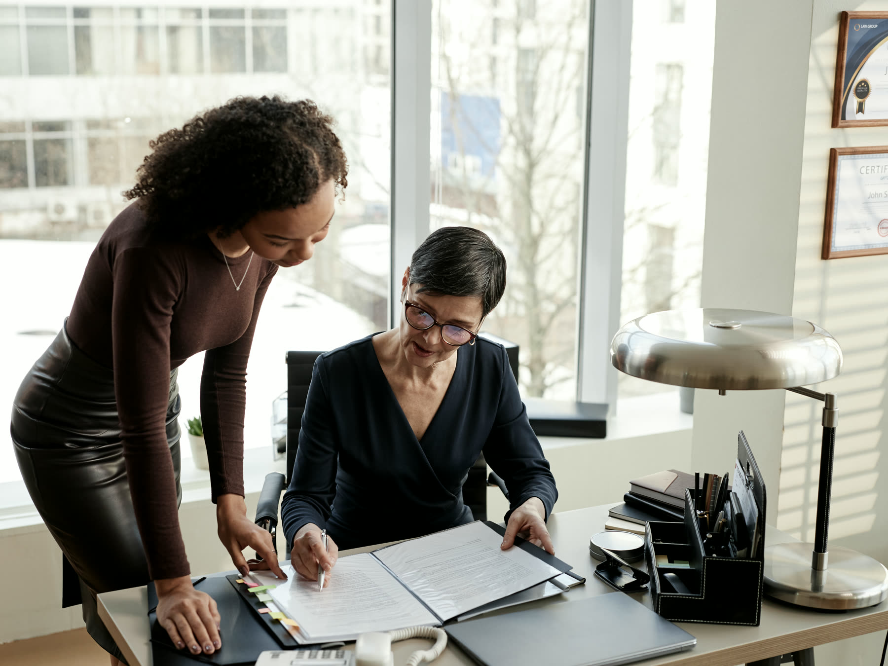 A solicitor working through case papers with a client