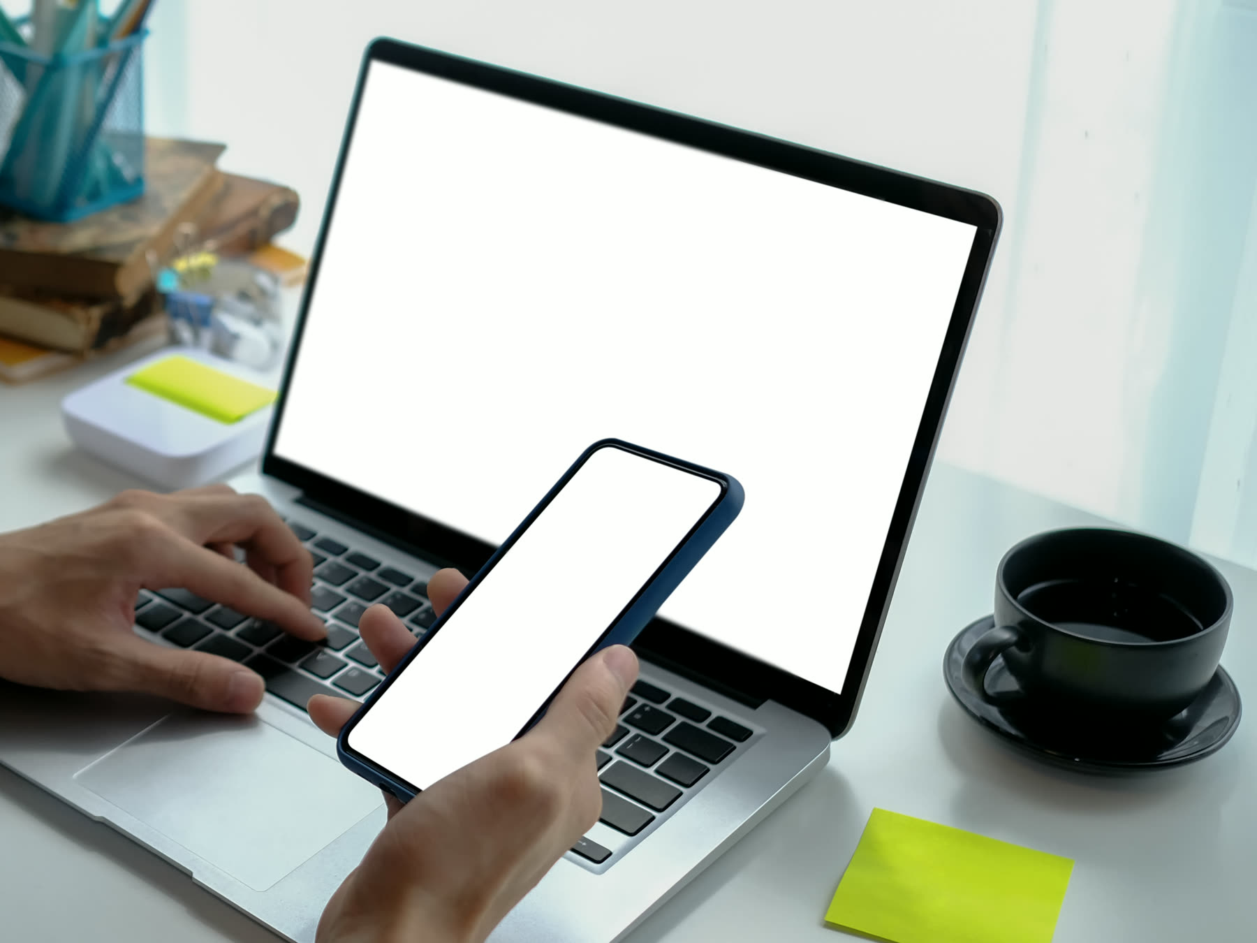 A website layout being reviewed on screen alongside a phone